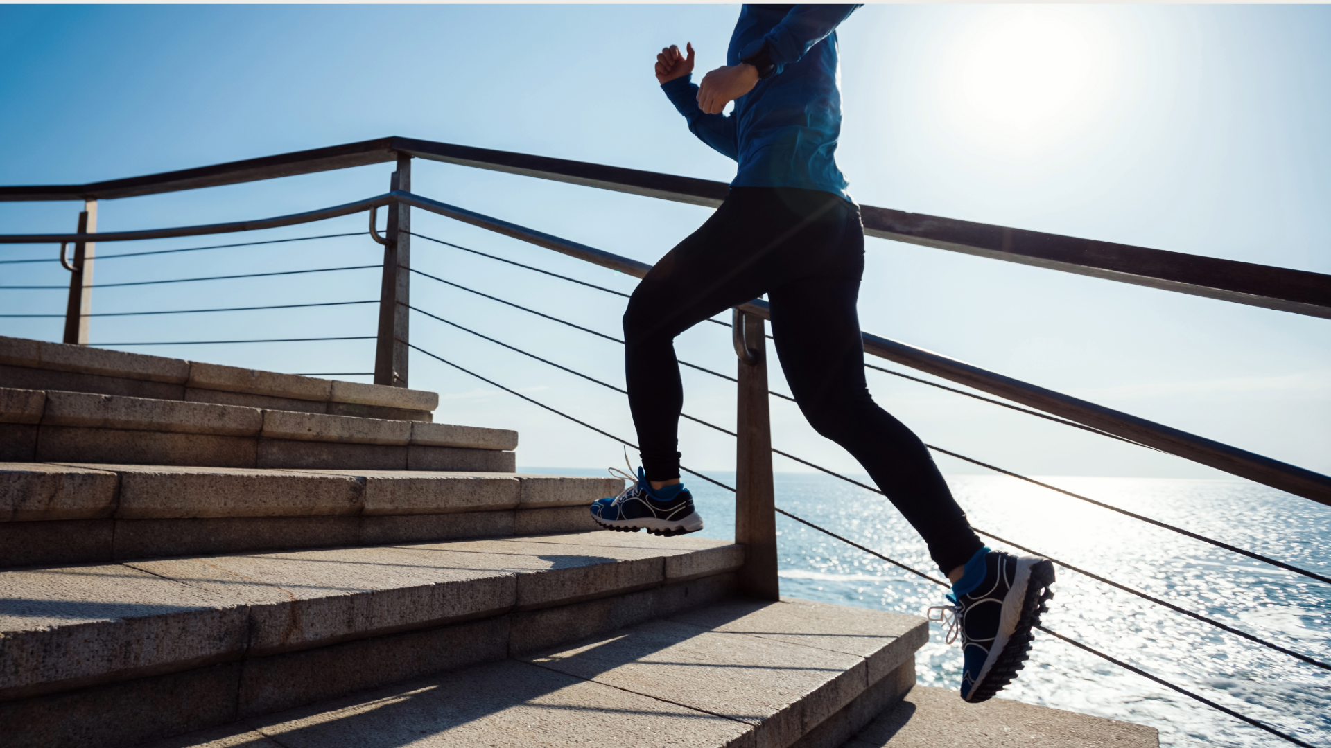 Sporty fitness female runner running up on seaside stairs